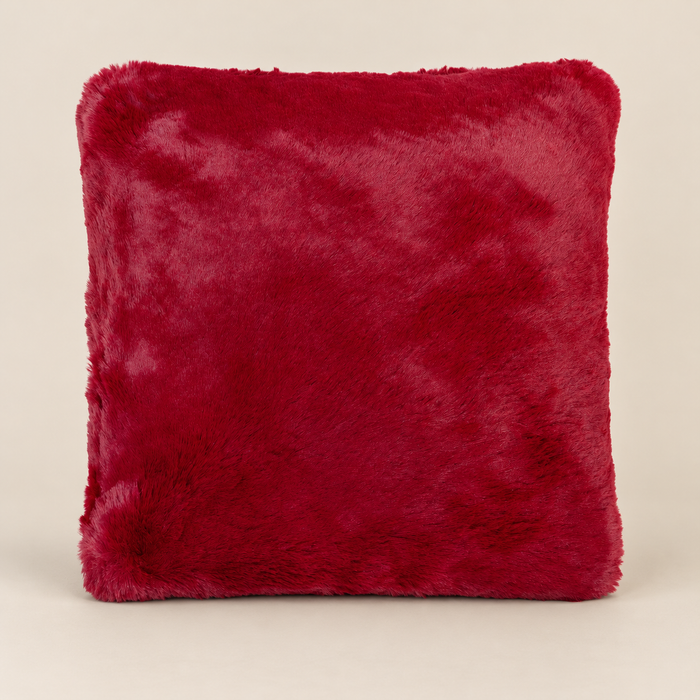 SUSAN Kunstfellkissen Burgundy 50 × 50 cm – Produktansicht auf warmem beigem Hintergrund